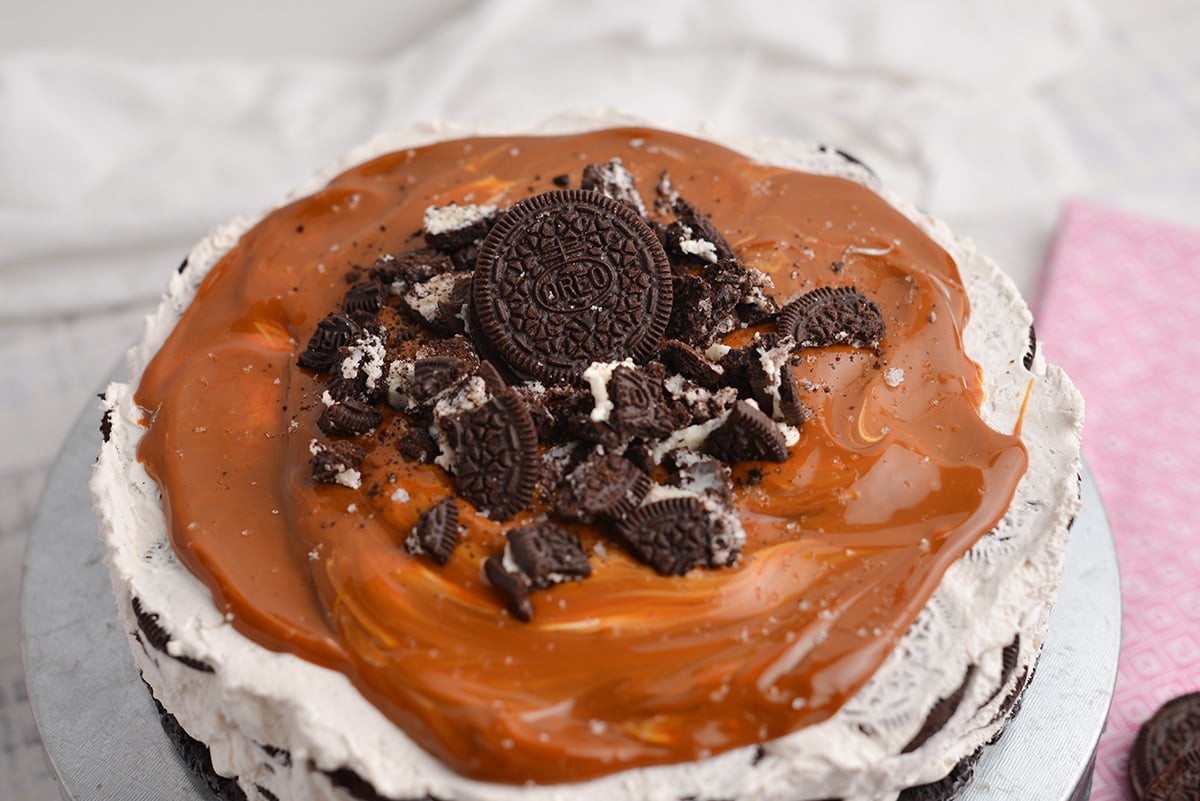 angle view of no-bake oreo cake with dulce de leche topping and crushed oreos