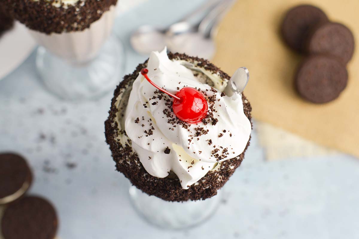 overhead of milkshake with a cherry and a spoon