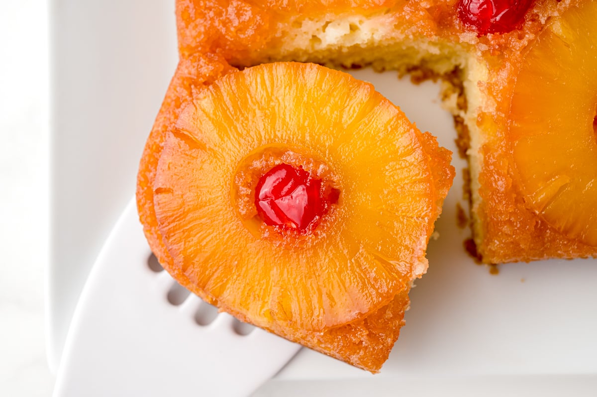 spatula on a corner slice of homemade pineapple cake