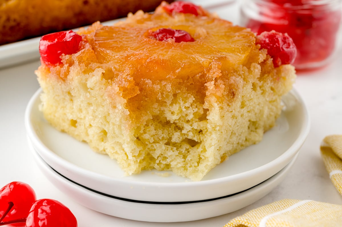 bite shot of easy pineapple upside down cake on staked plates