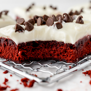 bite shot of homemade red velvet brownies on a wire rack