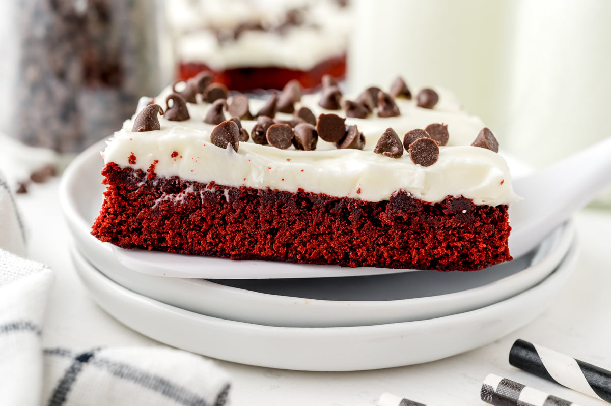 square red velvet brownie on a stack of white plates