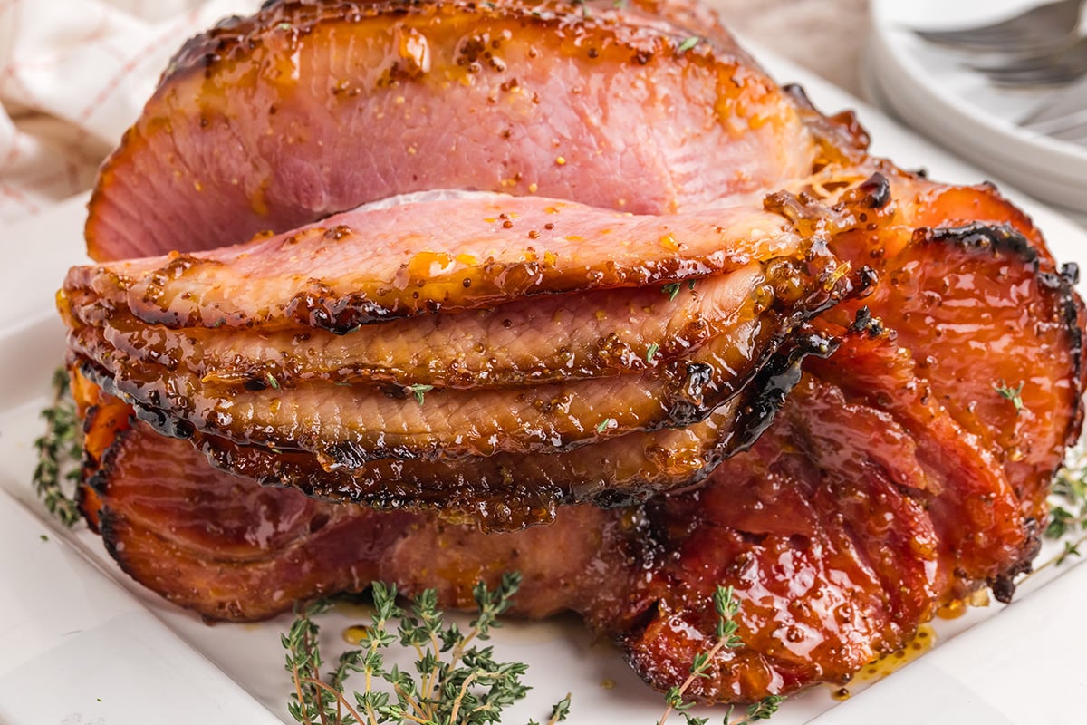 straight on shot of riesling peach glazed ham sliced on platter