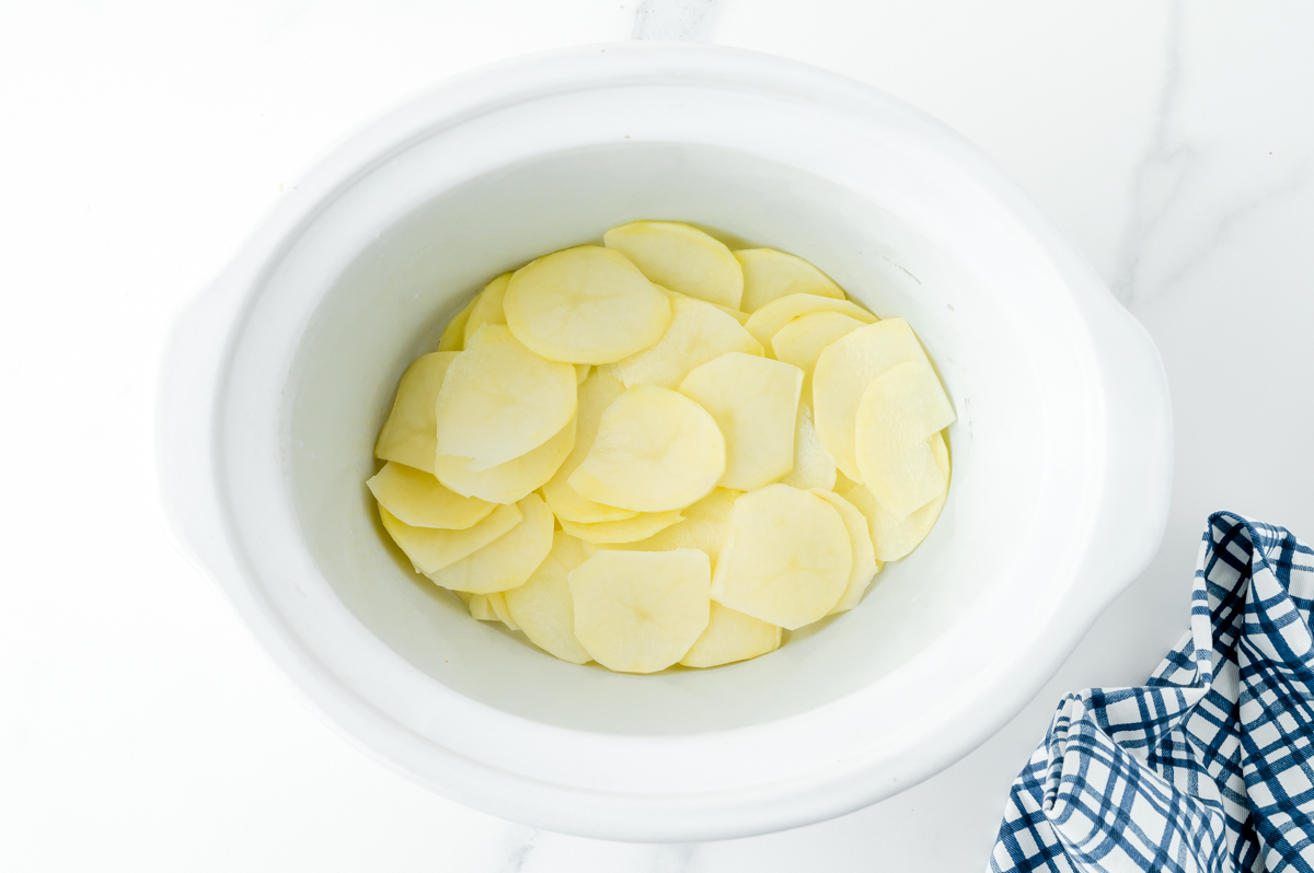 layer of potatoes in bottom of slow cooker