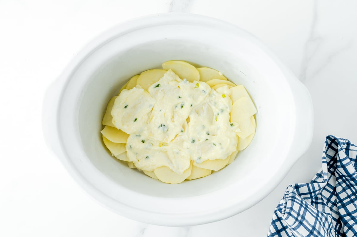 roux on top of layer of potatoes