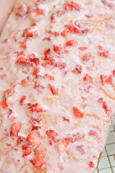 angle close up of pound cake with fresh strawberry icing