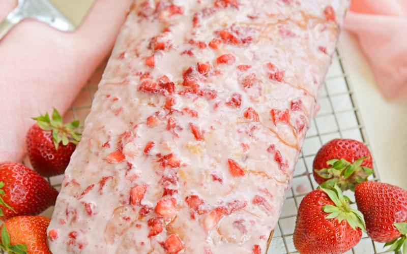 angle close up of pound cake with fresh strawberry icing