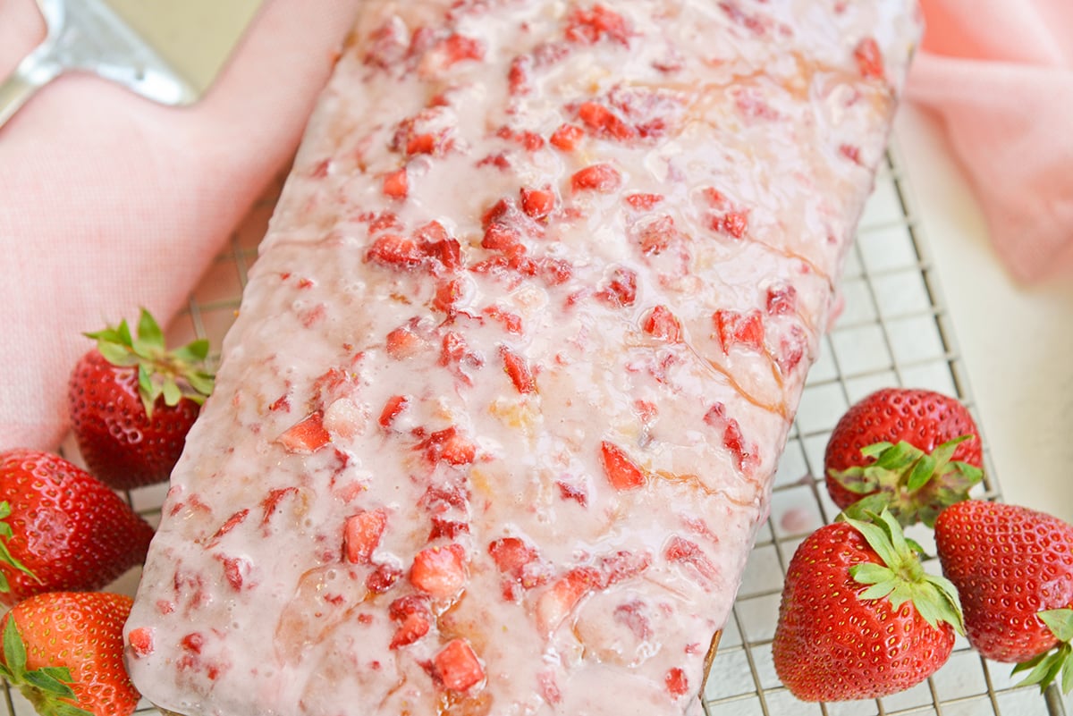 angle close up of pound cake with fresh strawberry icing