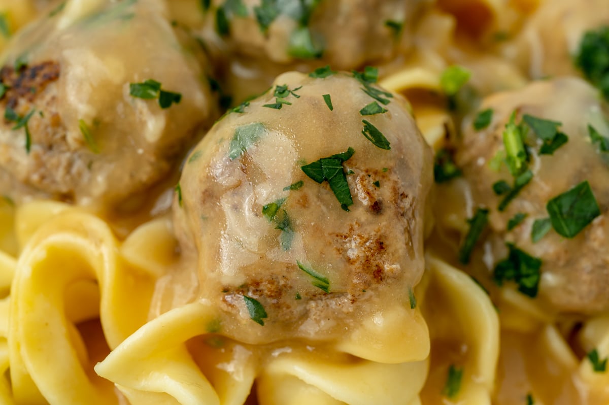 close up shot of swedish meatball on noodles
