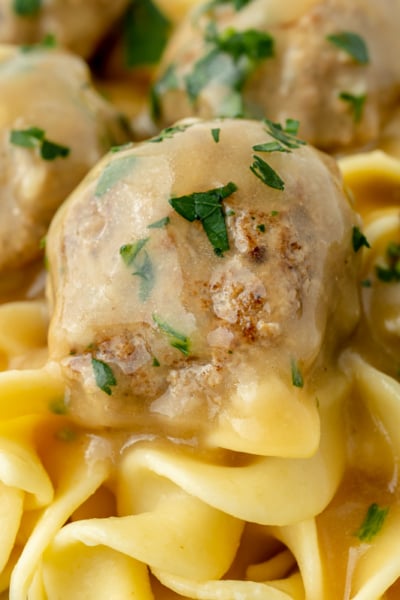 close up straight on shot of swedish meatballs on noodles