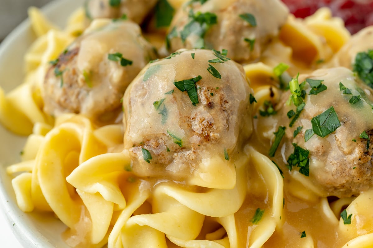 close up straight on shot of swedish meatballs on noodles