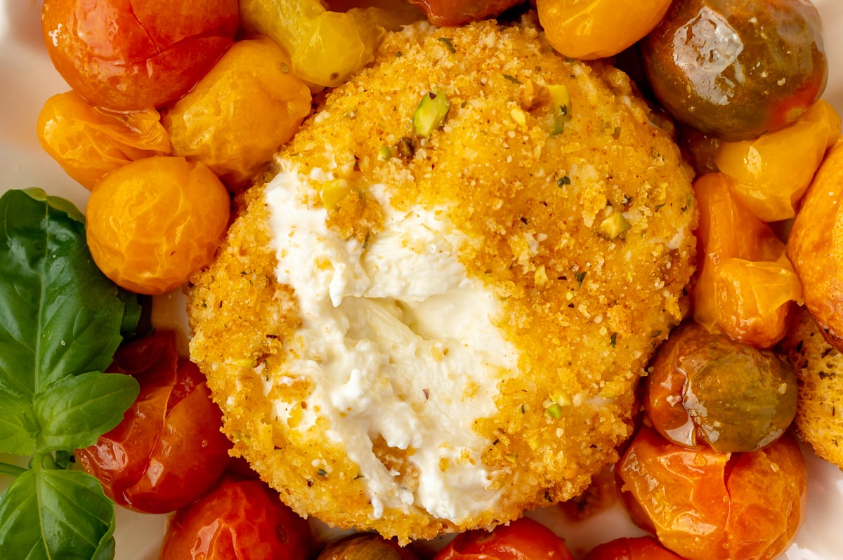 close up overhead shot of air fryer burrata on plate with tomatoes