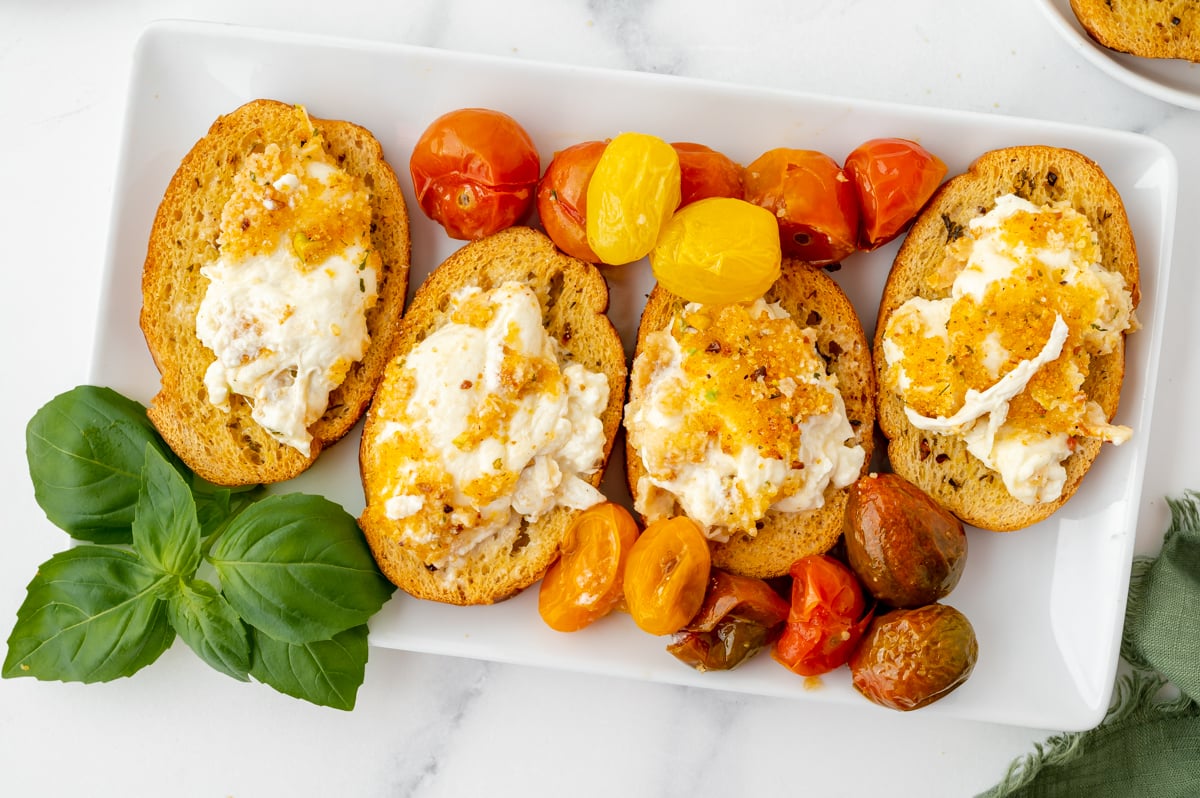 overhead shot of air fryer burrata spread onto four toasts