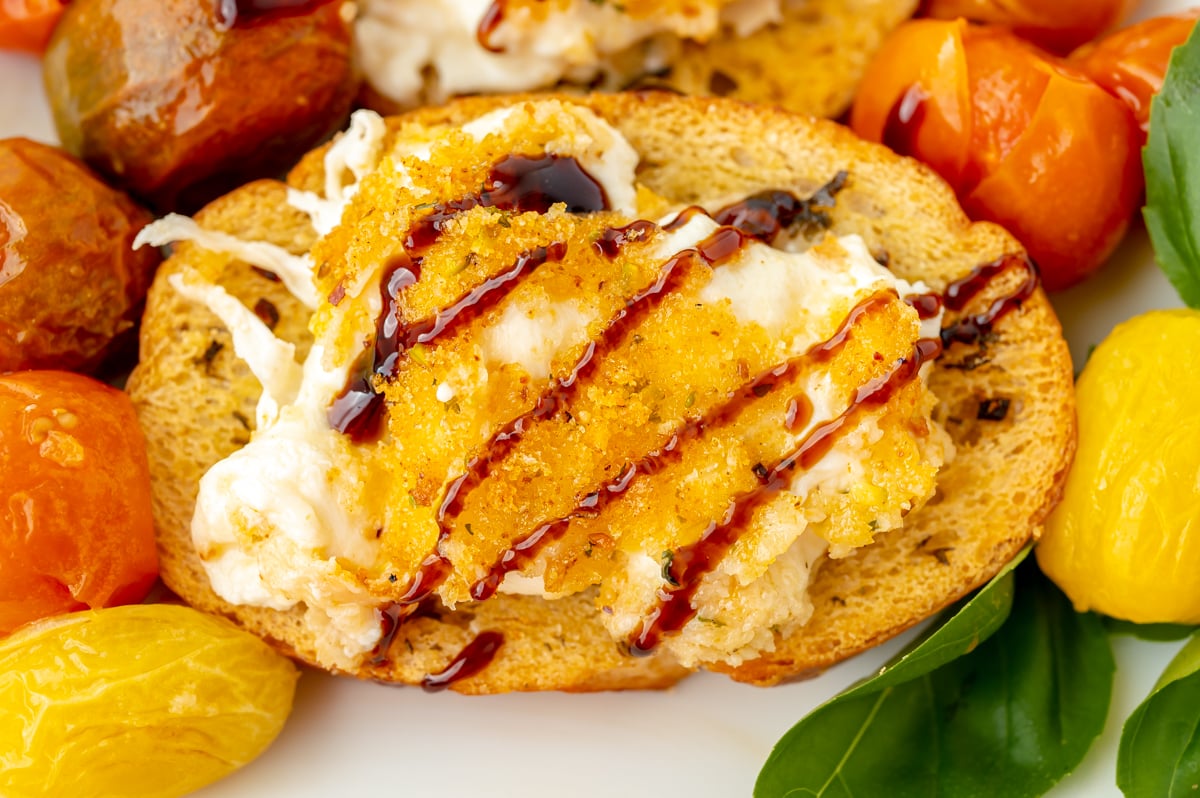 close up overhead shot of toast topped with cheese and balsamic glaze drizzle