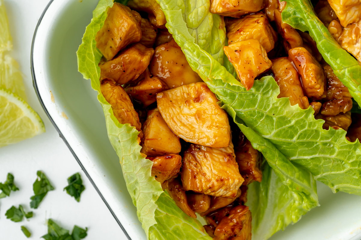 close up of bbq chicken wrapped in lettuce