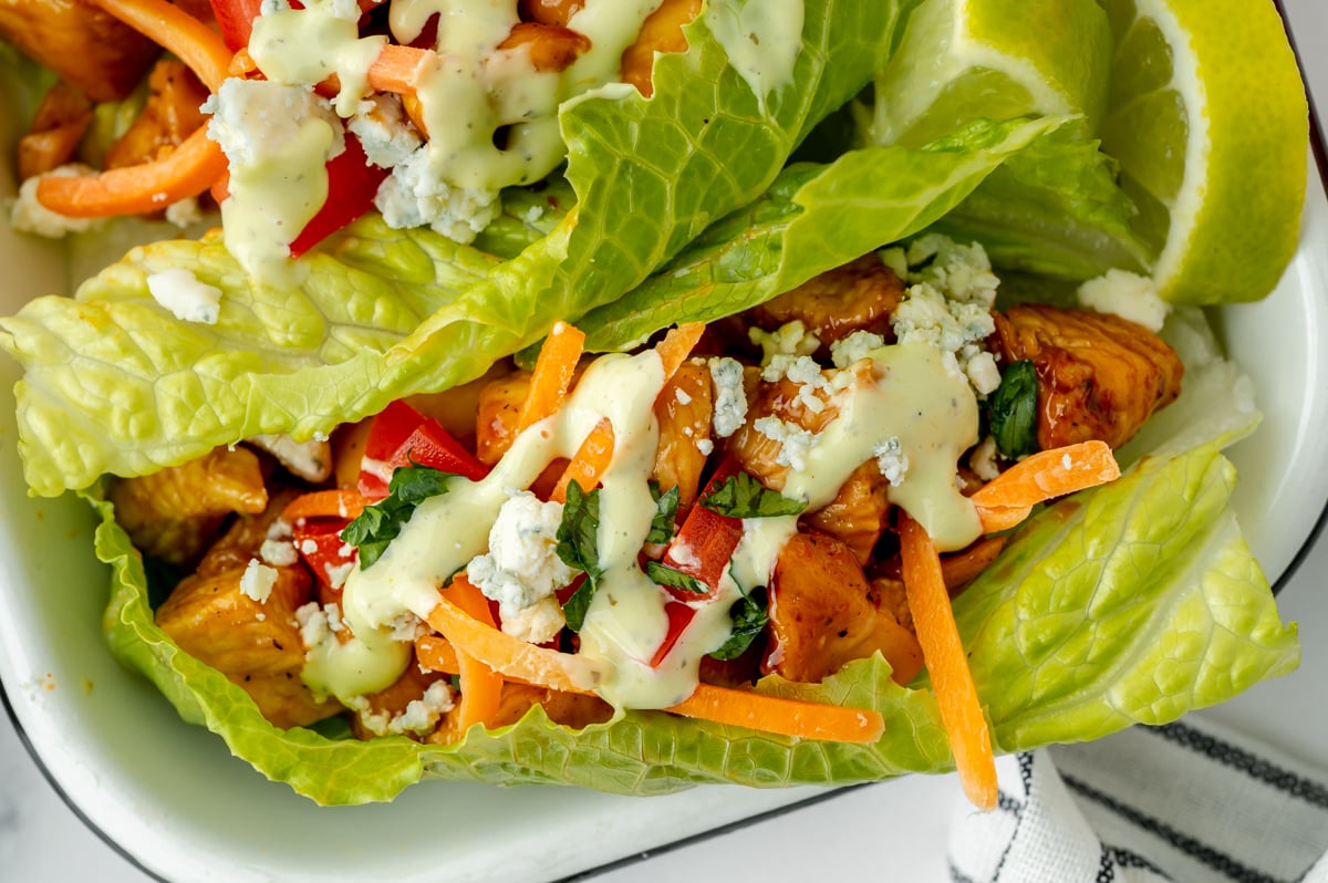 green goddess dressing drizzled over bbq chicken lettuce wrap