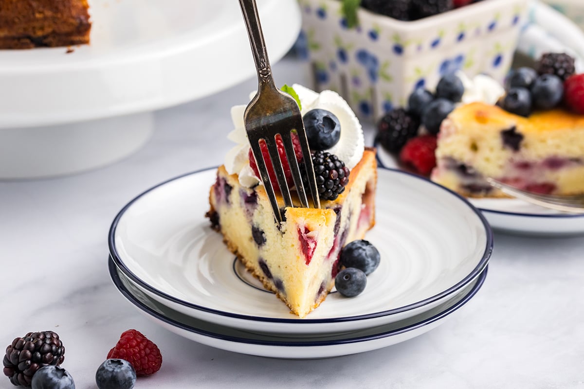 fork digging into slice of cheesecake