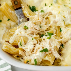 close up overhead shot of chicken Alfredo bake with serving spoon in it