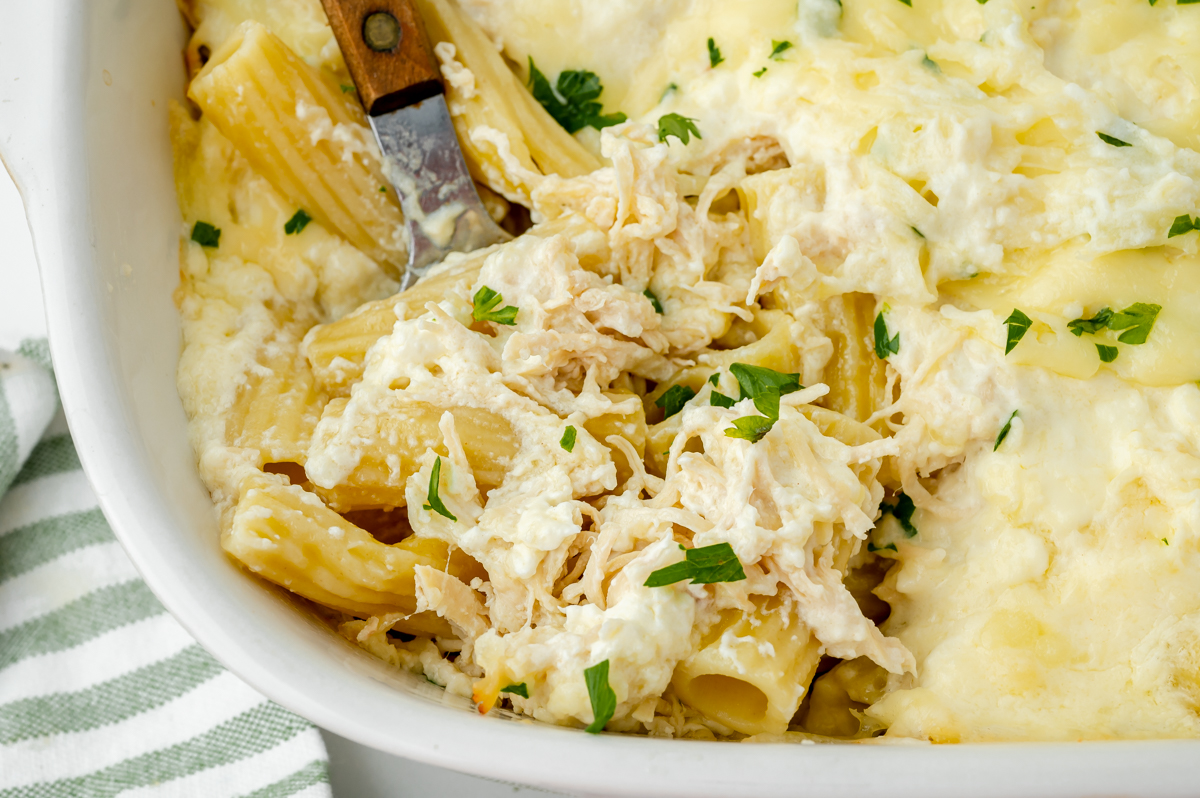 close up overhead shot of chicken Alfredo bake with serving spoon in it