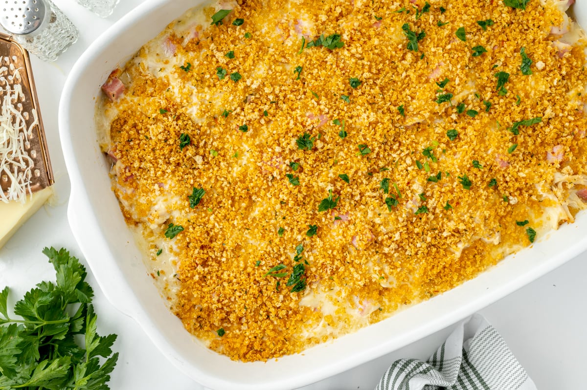 overhead shot of baked chicken cordon bleu casserole in baking dish