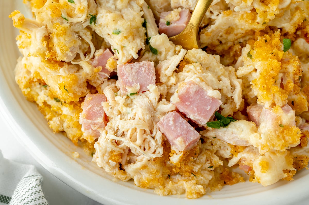 close up of fork in chicken cordon bleu casserole