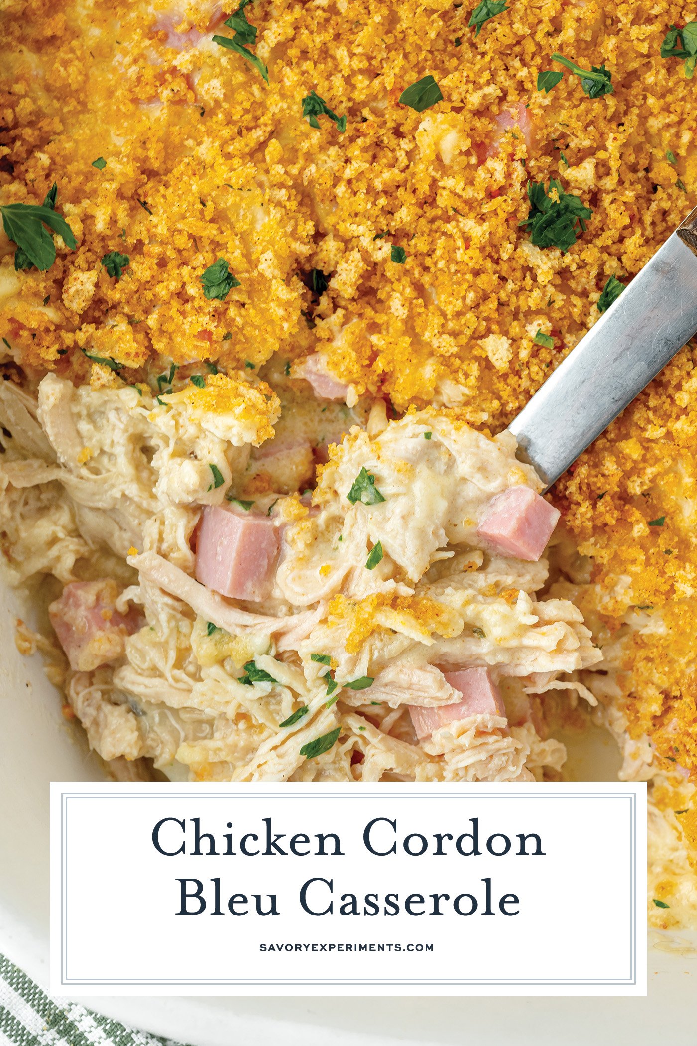 overhead shot of serving spoon in chicken cordon bleu casserole with text overlay