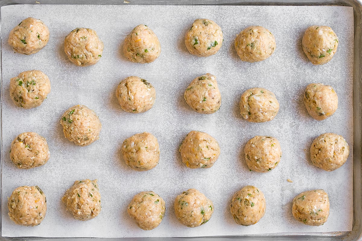 overhead shot of chicken meatballs on sheet pan