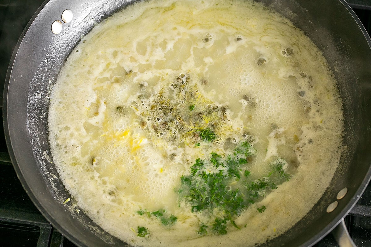 piccata sauce cooking in pan