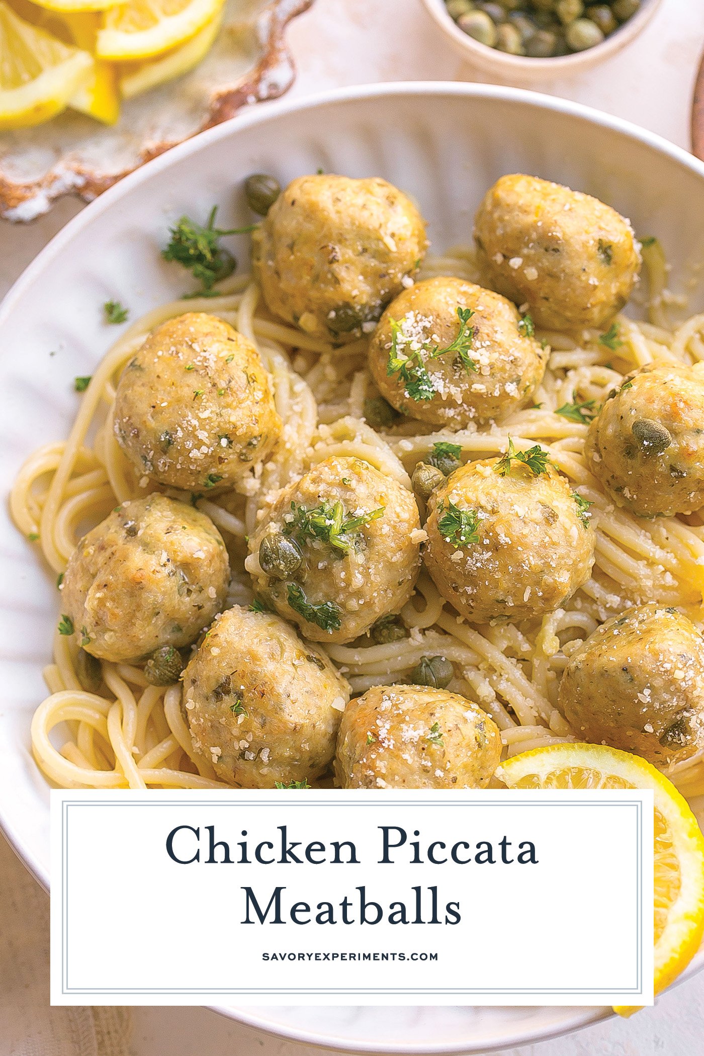 angled shot of chicken piccata meatballs over pasta with text overlay