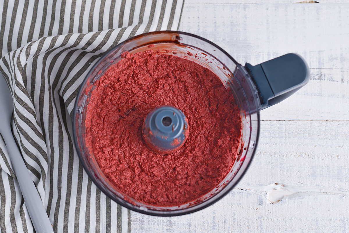 overhead shot of chocolate and pureed beets in food processor