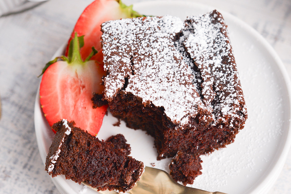 close up overhead shot of bite taken out of slice of chocolate beet cake