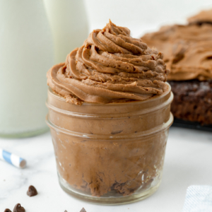 angled shot of jar of chocolate frosting