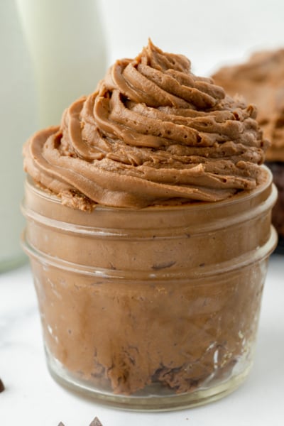 angled shot of jar of chocolate frosting