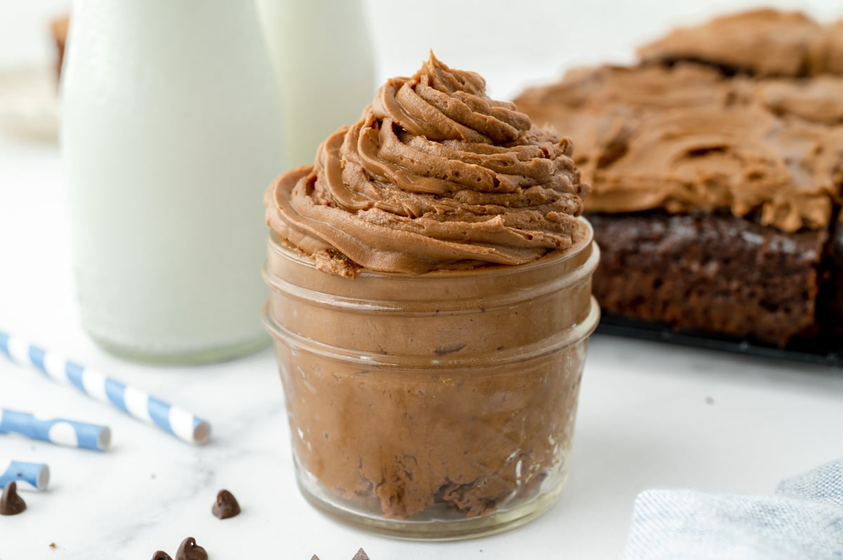 angled shot of jar of chocolate frosting