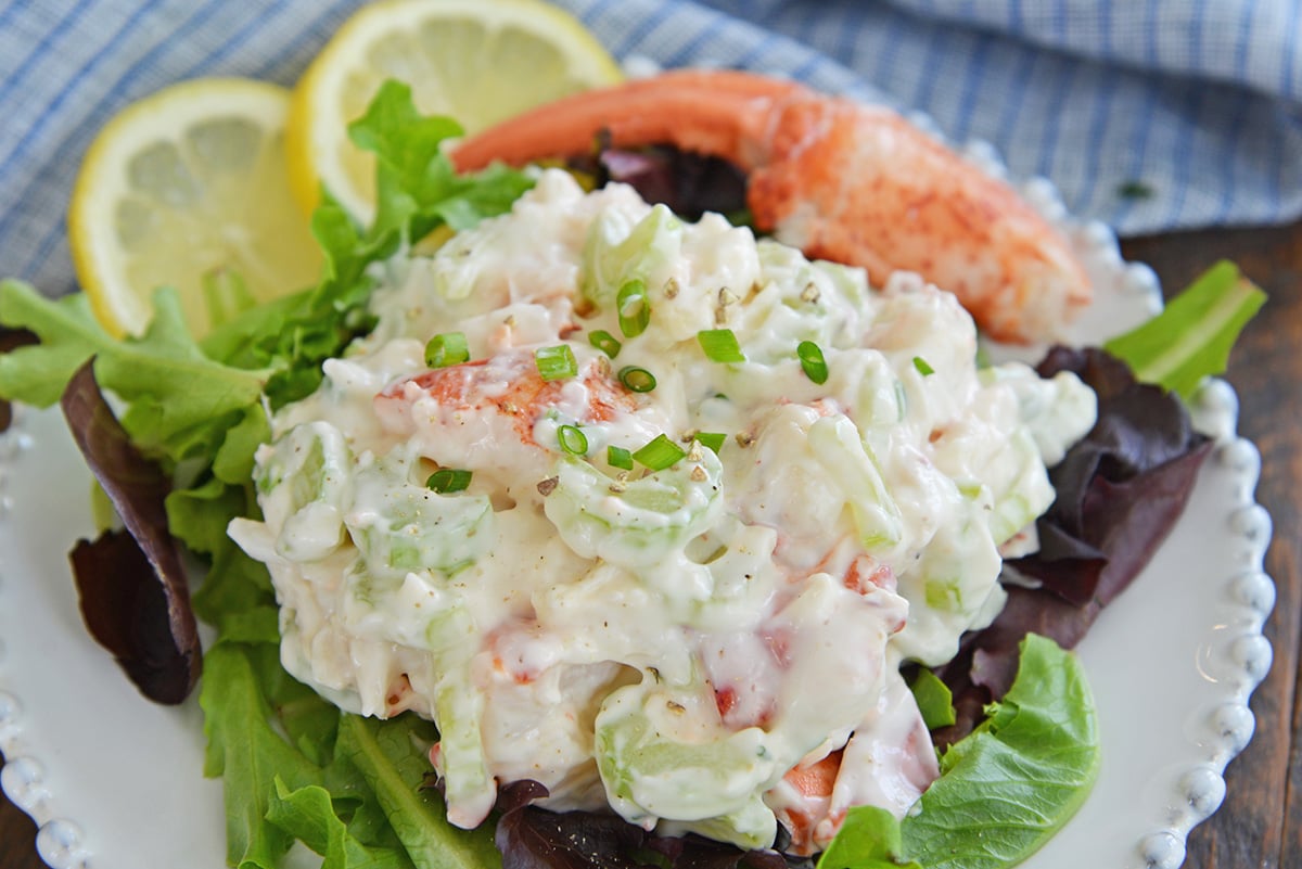 close up of cold lobster salad on greens