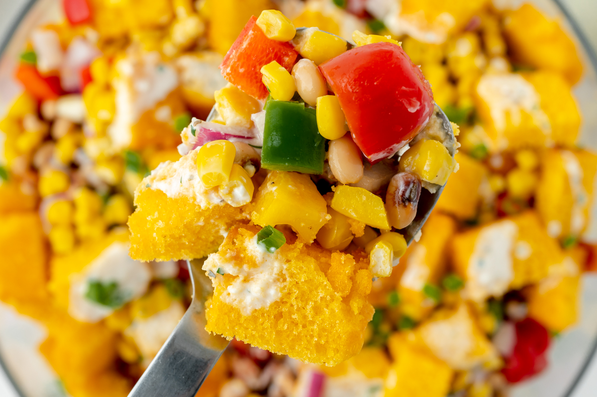 overhead shot of serving spoon full of cornbread salad