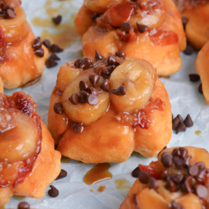 close up angled shot of mini fat elvis monkey breads on parchment paper