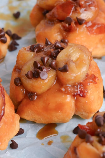 close up angled shot of mini fat elvis monkey breads on parchment paper