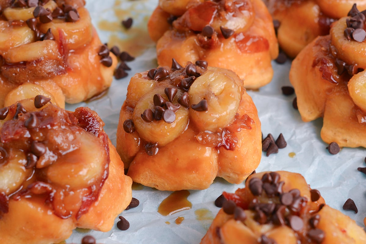 close up angled shot of mini fat elvis monkey breads on parchment paper