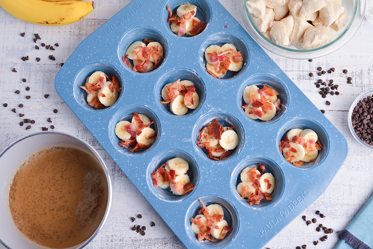 banana slices in muffin pan topped with crumbled bacon