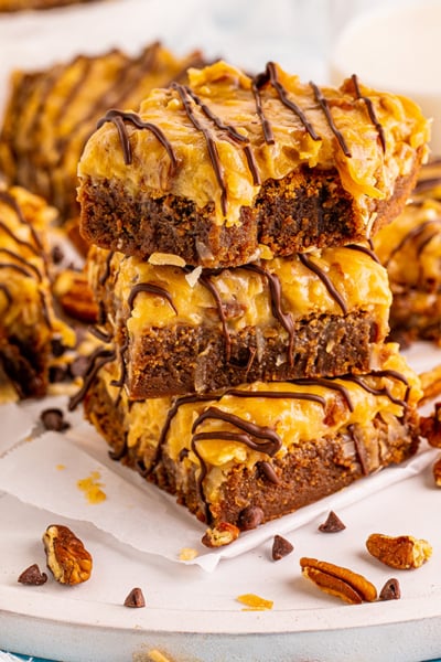 stack of chocolate caramel brownies with nuts and coconut caramel topping