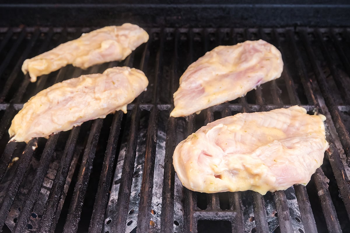 raw chicken on grill