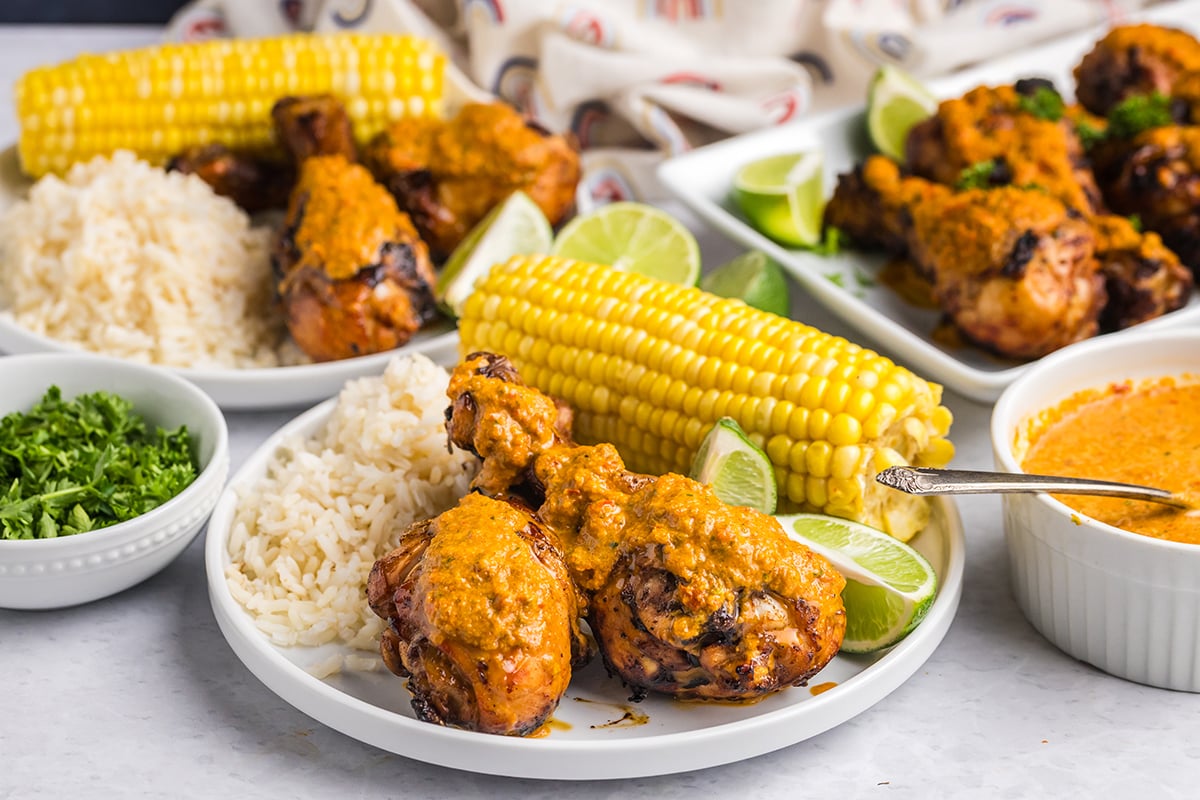plate of peri peri chicken with rice and corn
