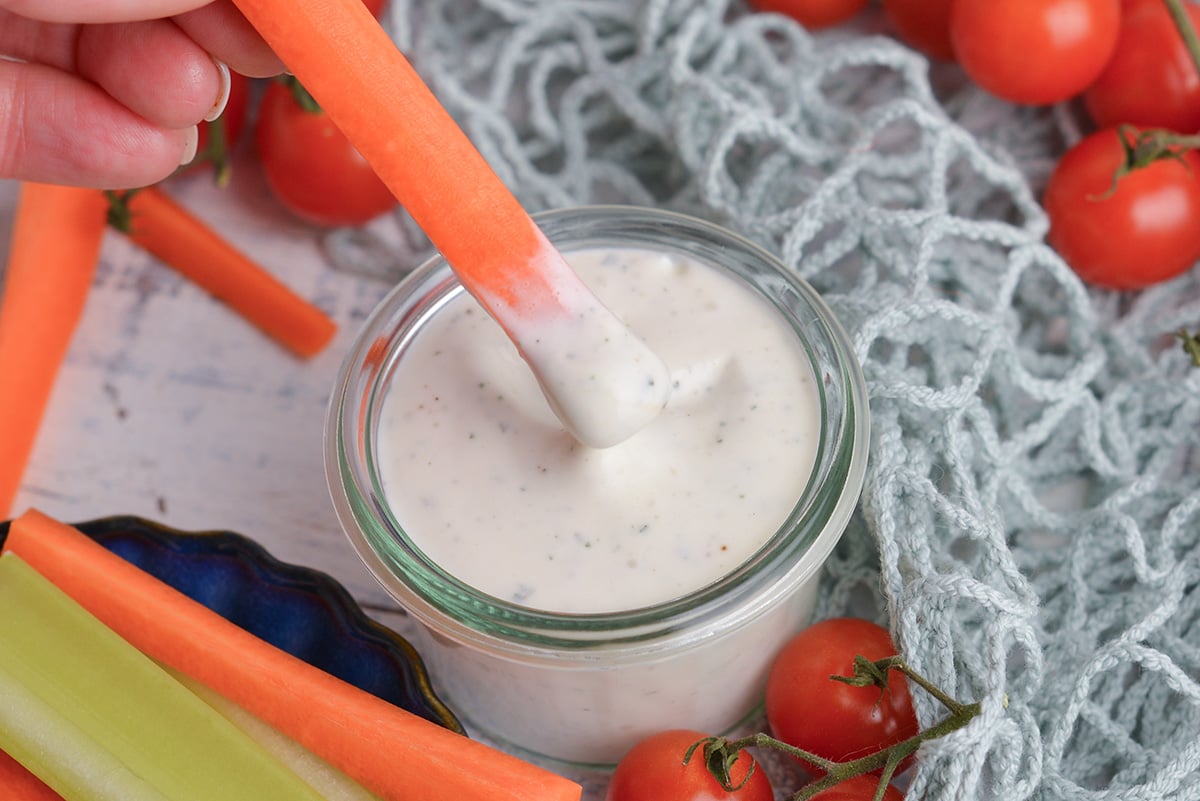 carrot stick dipping into jar of light ranch