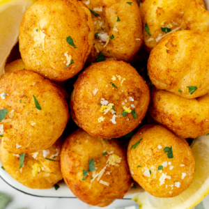 close up overhead shot of tray of lemon ricotta fritters