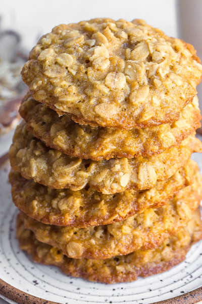 stack of quaker oats oatmeal cookies on a white speckled plate