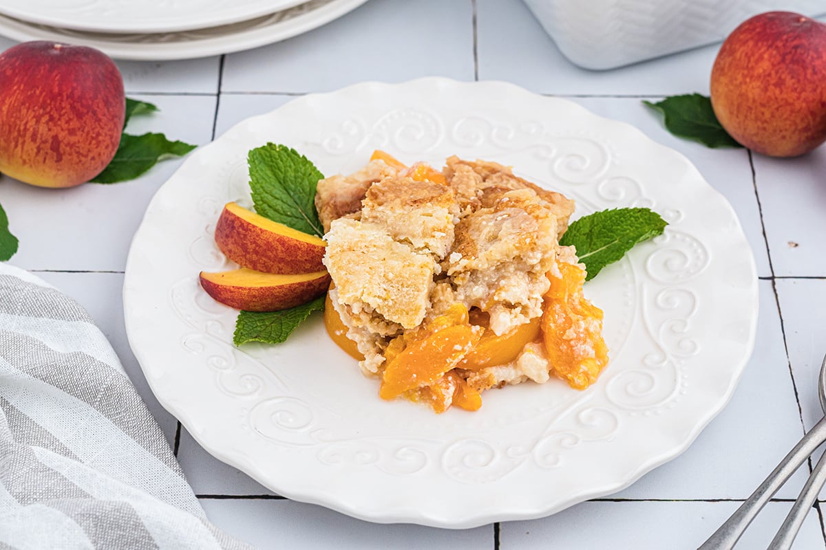 peach dump cake on a white plate