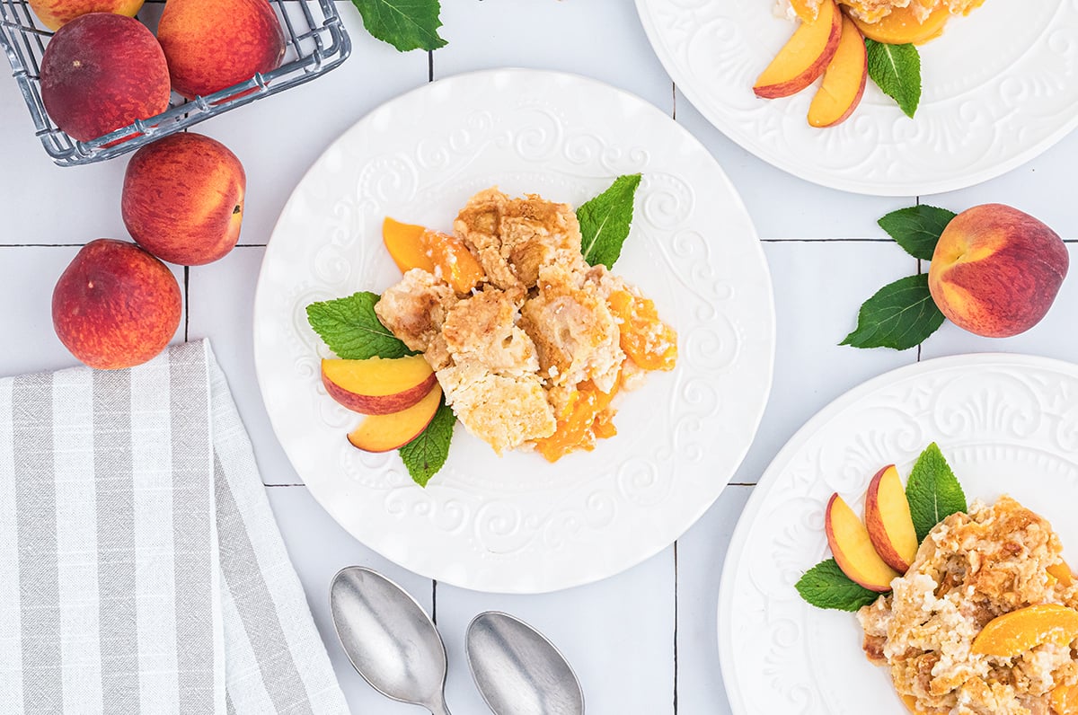 overhead shot of scoop of peach dump cake on plate