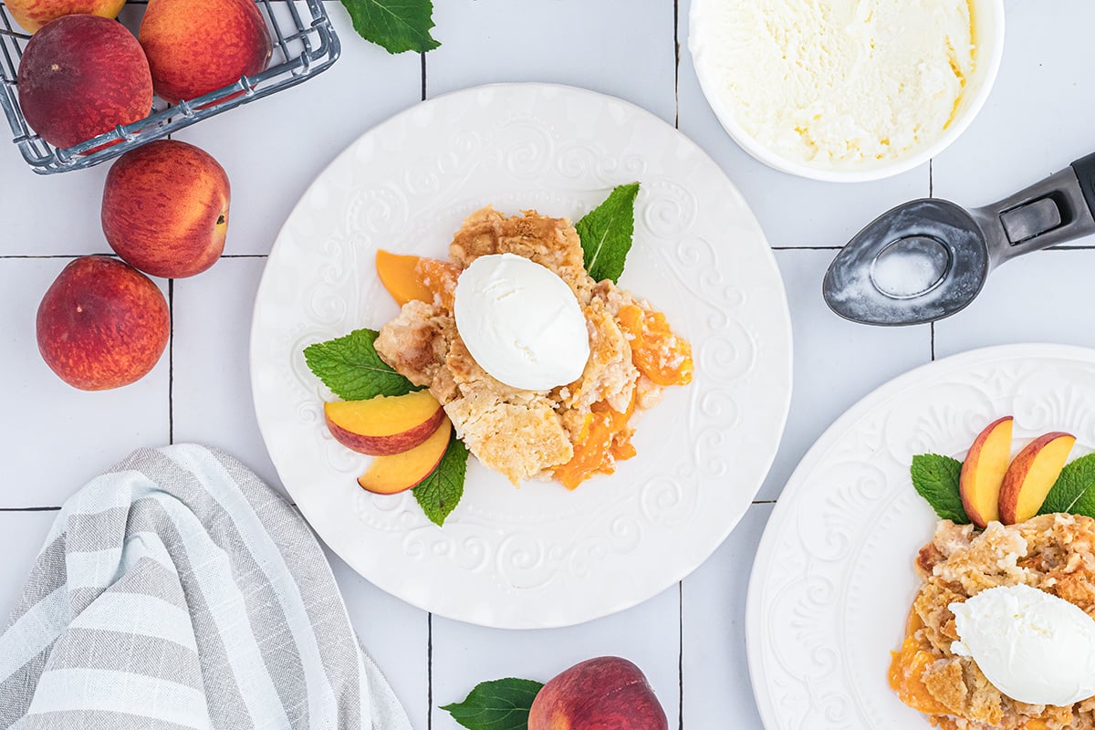 overhead shot of peach dump cake topped with ice cream