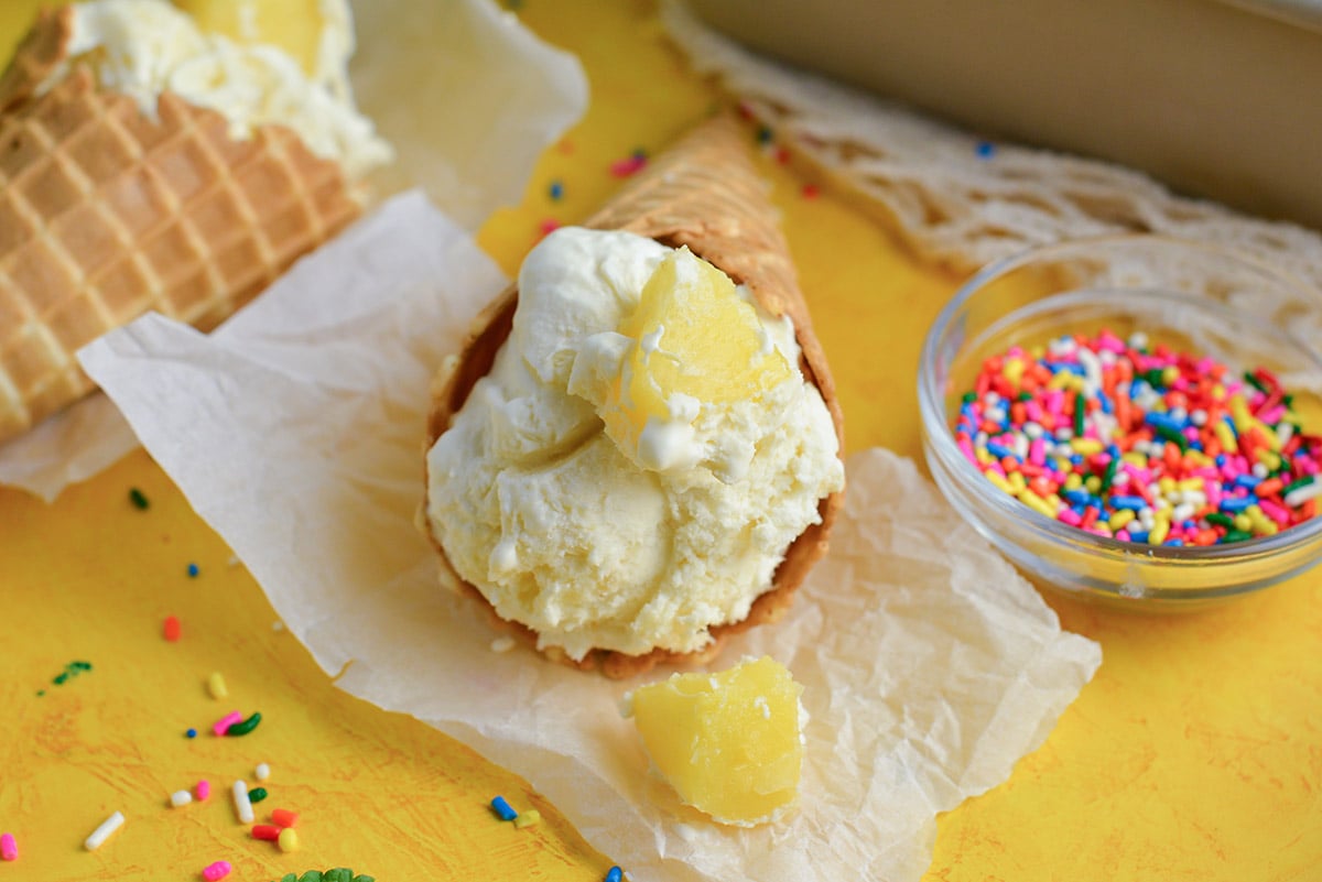 close up head on images of homemade ice cream with fruit chunks and rainbow sprinkles